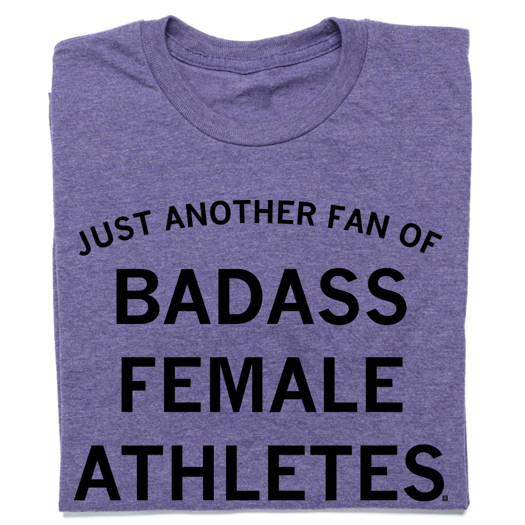 A sweatshop-free purple t-shirt featuring the black text JUST ANOTHER FAN OF BADASS FEMALE ATHLETES.