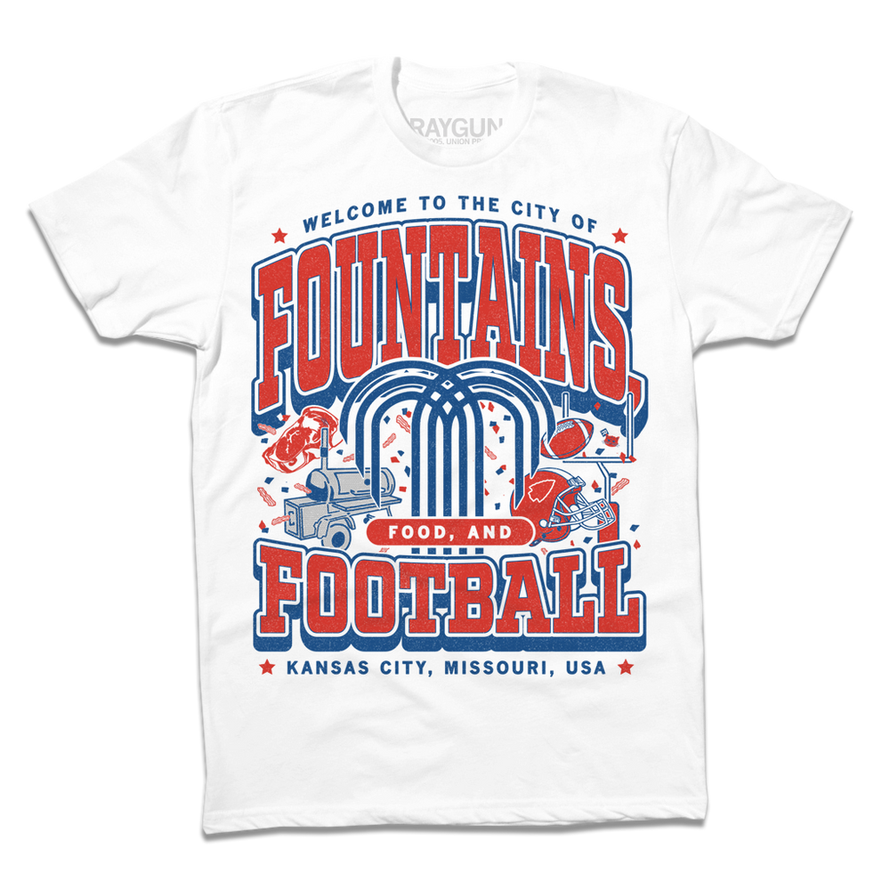 A white shirt with red and royal blue ink that says, "Welcome to the city of fountains, food, and football. Kansas City, Missouri USA" with a fountain, football, helmet, goalpost, smoker, and steak in the background.