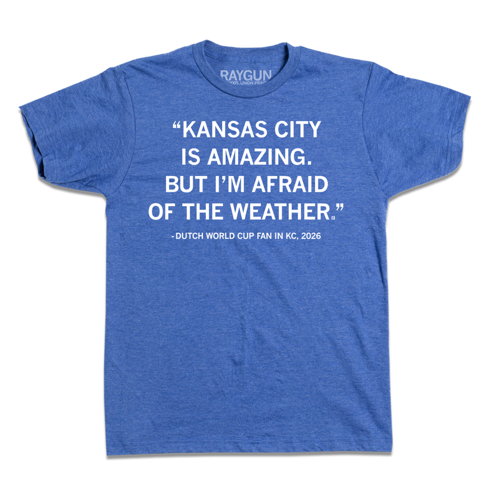 Heather royal blue t-shirt with white ink text that says, "Kansas City is amazing, but I'm afraid of the weather." - Dutch World Cup Fan in KC, 2026."