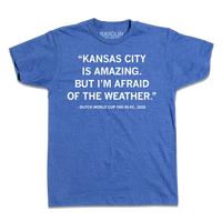 Heather royal blue t-shirt with white ink text that says, "Kansas City is amazing, but I'm afraid of the weather." - Dutch World Cup Fan in KC, 2026."