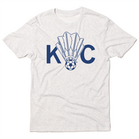 Triblend heather white t-shirt with royal blue ink depicting a shuttlecock with a soccer ball at the end of it between the letters KC.