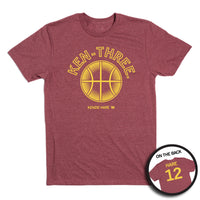 A heather burgundy t-shirt with gold ink that says, "Ken-three" above a basketball on the front and "Hare 12" on the back.