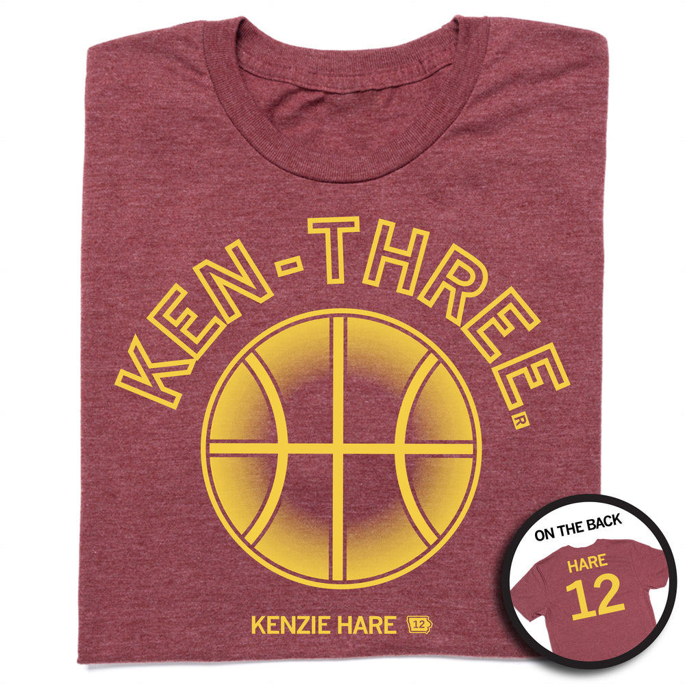 Folded heather burgundy tee with gold ink that says, "Ken-three" over a basketball on the front and "Hare 12" on the back.