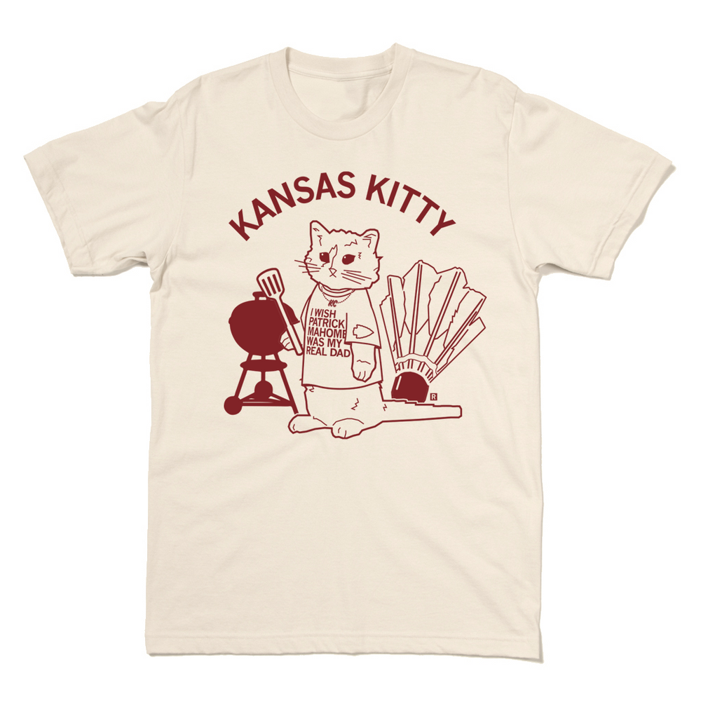 Natural shirt with cardinal ink that says, "Kansas Kitty" above an illustration of a cat barbecuing while wearing a Kansas City Chiefs shirt.