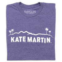 A folded heather purple t-shirt with white screen print depicting the Hollywood sign as saying, "Kate Martin."