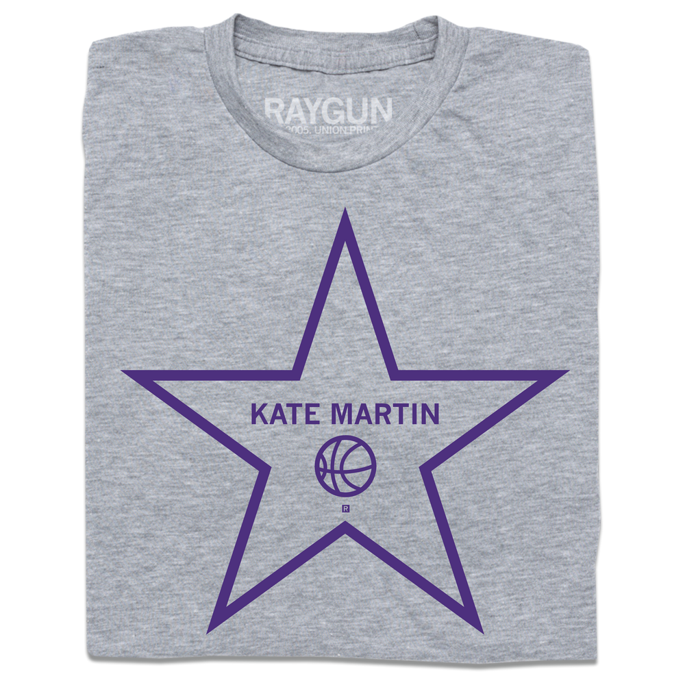 A folded heather grey t-shirt with purple ink depicting a Hollywood start that says, "Kate Martin" above a basketball.