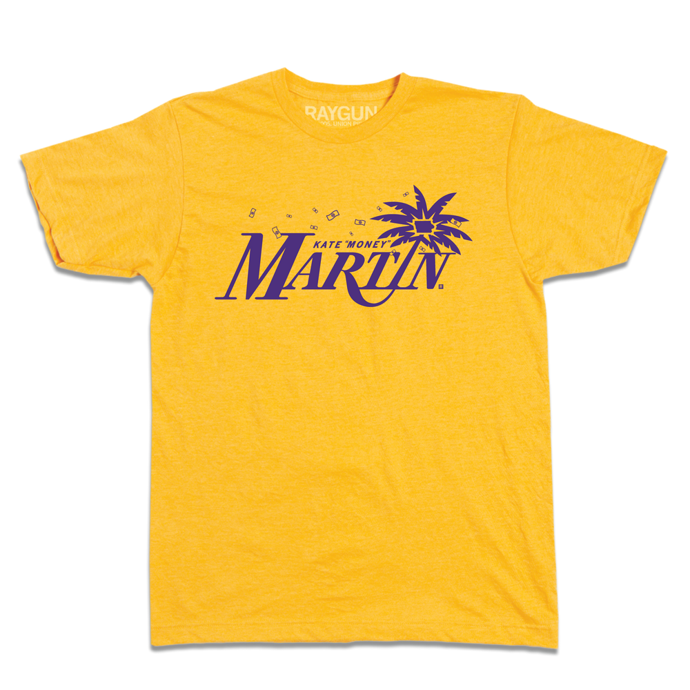Heather gold t-shirt with purple ink that reads "Kate "Money" Martin" with the I being a leaning palm tree that has the state of Iowa in the center of its leaves. There are also flying dollar bills above the text.