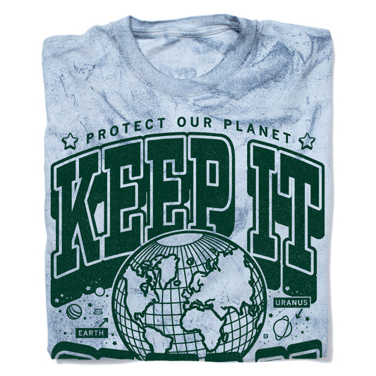 Light blue, garment-dyed, acid-wash collegiate t-shirt with a graphic that reads Protect Our Planet and Keep It in large green letters above a line drawing of Earth, with small illustrations of planets labeled Earth and Uranus.
