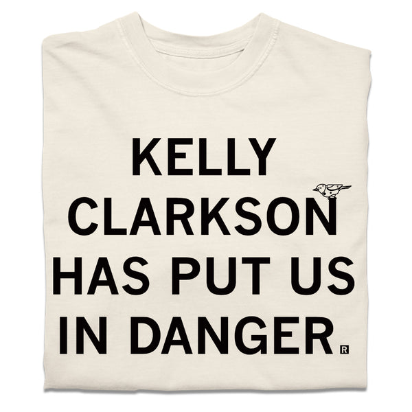 A folded cream heavyweight t-shirt with blank ink text that says, 