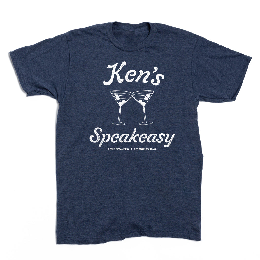 Heather denim blue short-sleeved t-shirt with a white graphic of two martini glasses and the text Ken’s Speakeasy • Des Moines, Iowa.