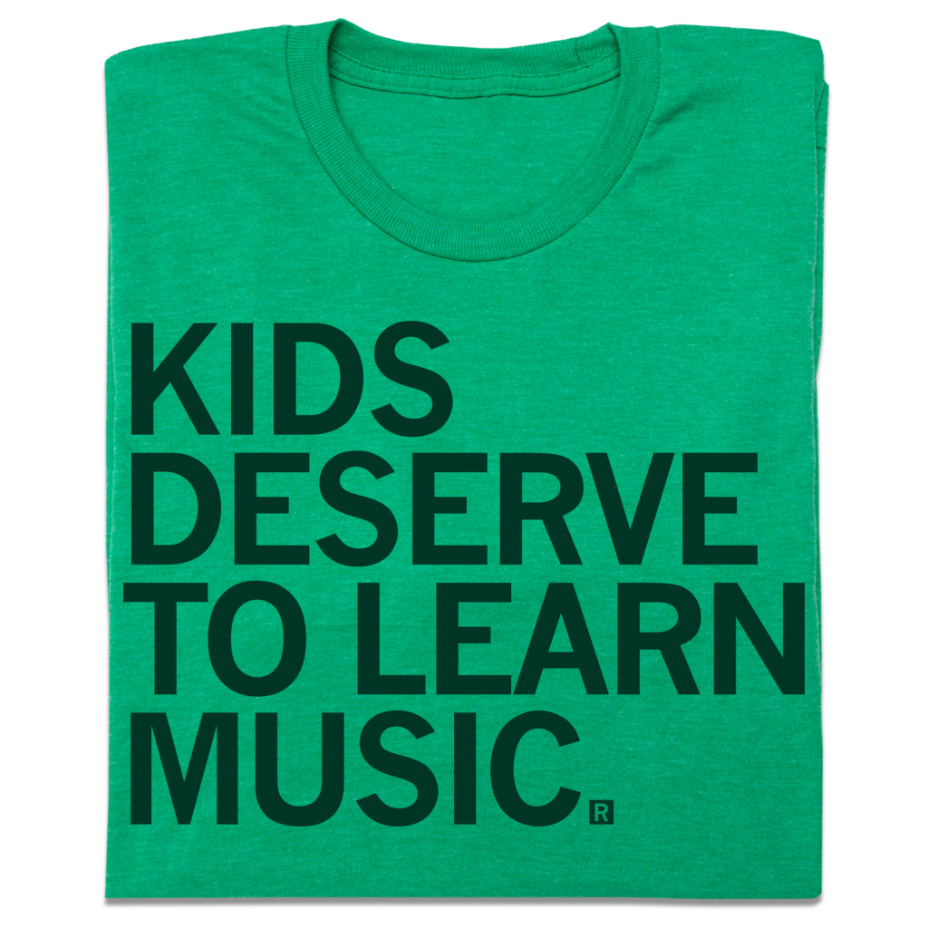 Green heather kelly T-shirt with the text KIDS DESERVE TO LEARN MUSIC. printed in dark green block letters.