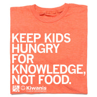 A folded heather orange t-shirt with left aligned white print that reads "Keep kids hungry for knowledge, not food" with the HACAP and Kiwanis Club of Cedar Rapids logos in the bottom left.