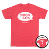 Heather red shirt that depicts a speech bubble in white ink that reads "Simon Says" and has "Kristen Simon" at the bottom along with "Simon 7" on the back.
