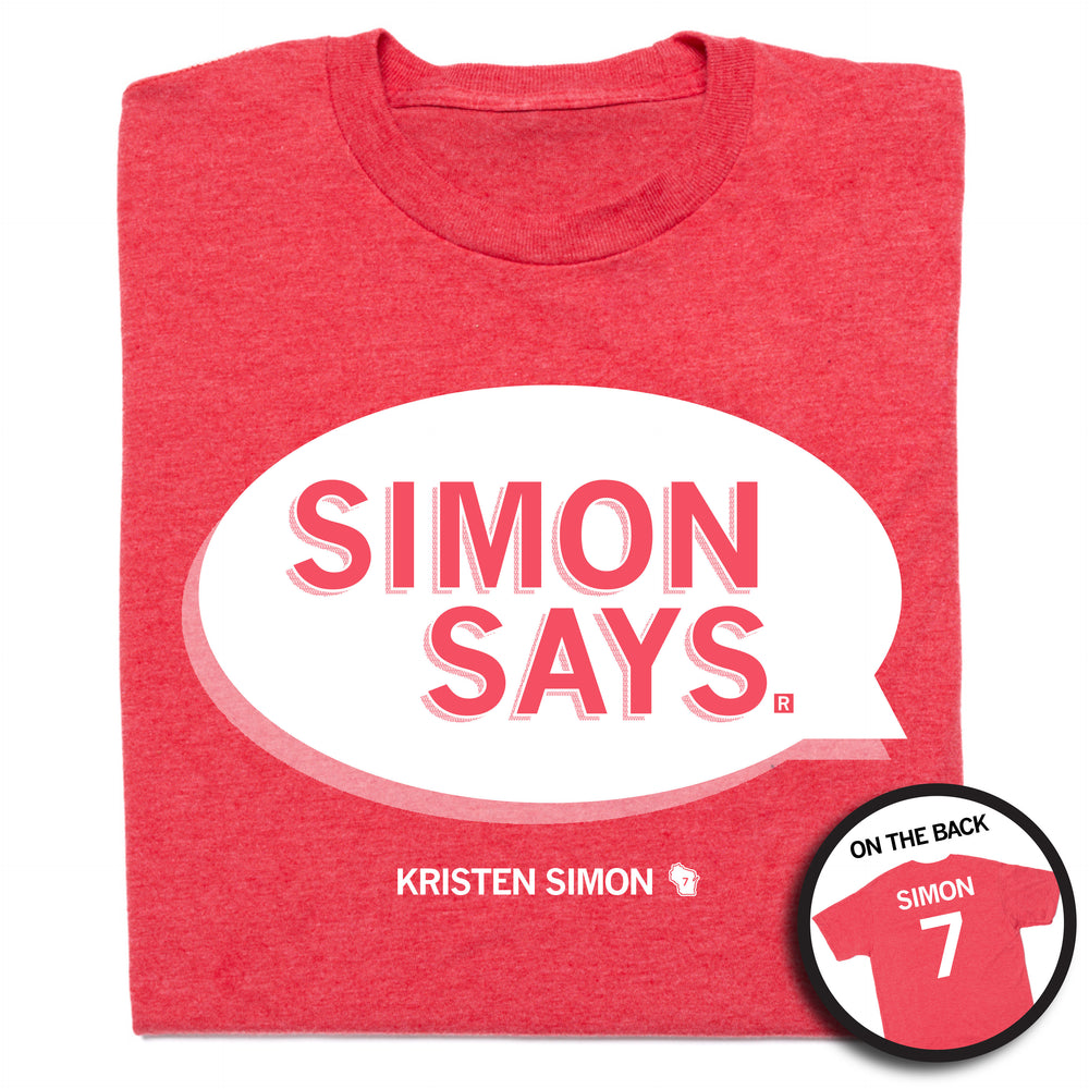 A heather red t-shirt that depicts a speech bubble in white ink that reads "Simon Says" and has "Kristen Simon" at the bottom along with "Simon 7" on the back.