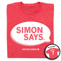 A heather red t-shirt that depicts a speech bubble in white ink that reads "Simon Says" and has "Kristen Simon" at the bottom along with "Simon 7" on the back.