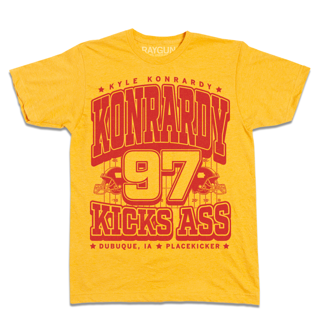 Heather Mellow Yellow t-shirt with red graphic text reading Kyle Konrardy, Konrardy, 97, and Kicks Ass, featuring football helmet icons and the text Dubuque, IA and Placekicker.