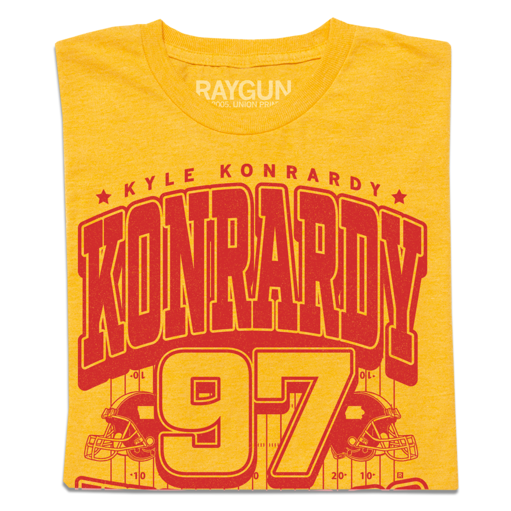 Heather Mellow Yellow t-shirt featuring a red graphic with the name Kyle Konrardy, the surname in large letters, and the number 97 above an illustration of a football field.
