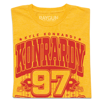 Heather Mellow Yellow t-shirt featuring a red graphic with the name Kyle Konrardy, the surname in large letters, and the number 97 above an illustration of a football field.