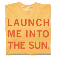 A folded gold heavyweight t-shirt with centered orange ink text that says, "Launch me into the sun"