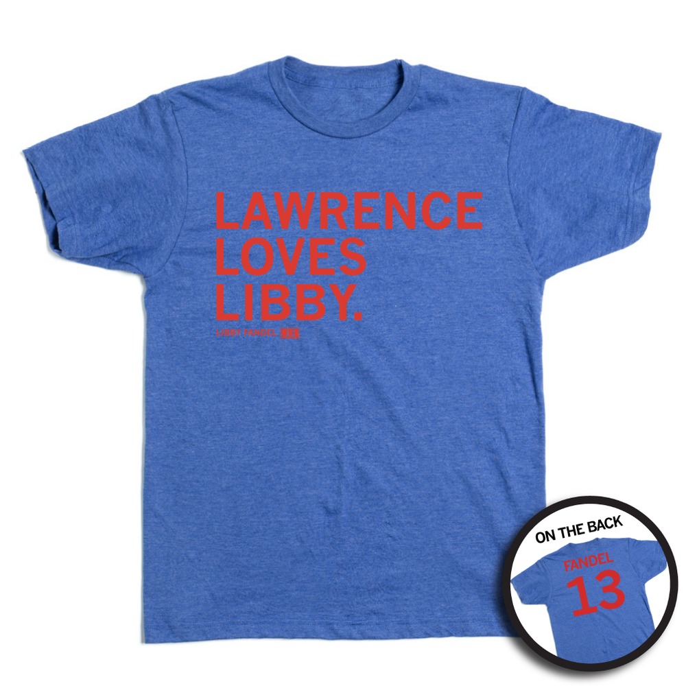 A heather blue tee with red ink in left aligned texthat reads "Lawence Loves Libby. Libby Fandel 13" on the front and "Fandel 13" on the back styled like a jersey.