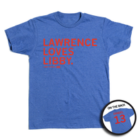 A heather blue tee with red ink in left aligned texthat reads "Lawence Loves Libby. Libby Fandel 13" on the front and "Fandel 13" on the back styled like a jersey.