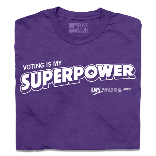 A folded purple union-made T-shirt featuring the text VOTING IS MY SUPERPOWER in white, alongside the League of Women Voters of Dane County logo.