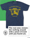 Heather denim t-shirt featuring a yellow graphic of a lion inside a circus wagon with the text Leo the Paper-Eating Lion and Lincoln, NE.