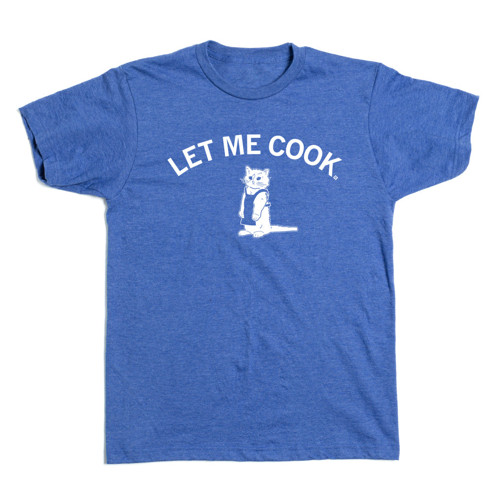 Heather Royal blue t-shirt featuring a white graphic of a cat wearing an apron, with the text LET ME COOK arched above it.
