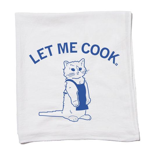 White flour sack kitchen towel featuring an aquamarine illustration of a cat wearing an apron, with the text LET ME COOK arched above it.