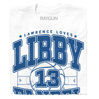 A folded white t-shirt with royal blue ink that says, "Lawrence loves" in small font above large text "Libby Fandel" with an illustration of a basketball court in the center and a giant basketball in the center with the number 13.