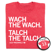 Folded heather red t-shirt with left-aligned white ink that reads "Wach the Wach. Talch the Talch" in all caps with "Lilly Wachholtz" printed in smaller text below. A circular image in the bottom right corner shows the back of the shirt. The back is printed like a jersey with "Wachholz" at the top above "13."