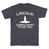 A union-made dark gray RAYGUN t-shirt featuring the text LINCOLN: ALWAYS HAPPY TO SEE YOU! above a white silhouette of the Nebraska State Capitol building.