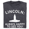 Dark gray RAYGUN crew neck t-shirt featuring the text LINCOLN: above a white silhouette of the Nebraska State Capitol building and the text ALWAYS HAPPY TO SEE YOU!.