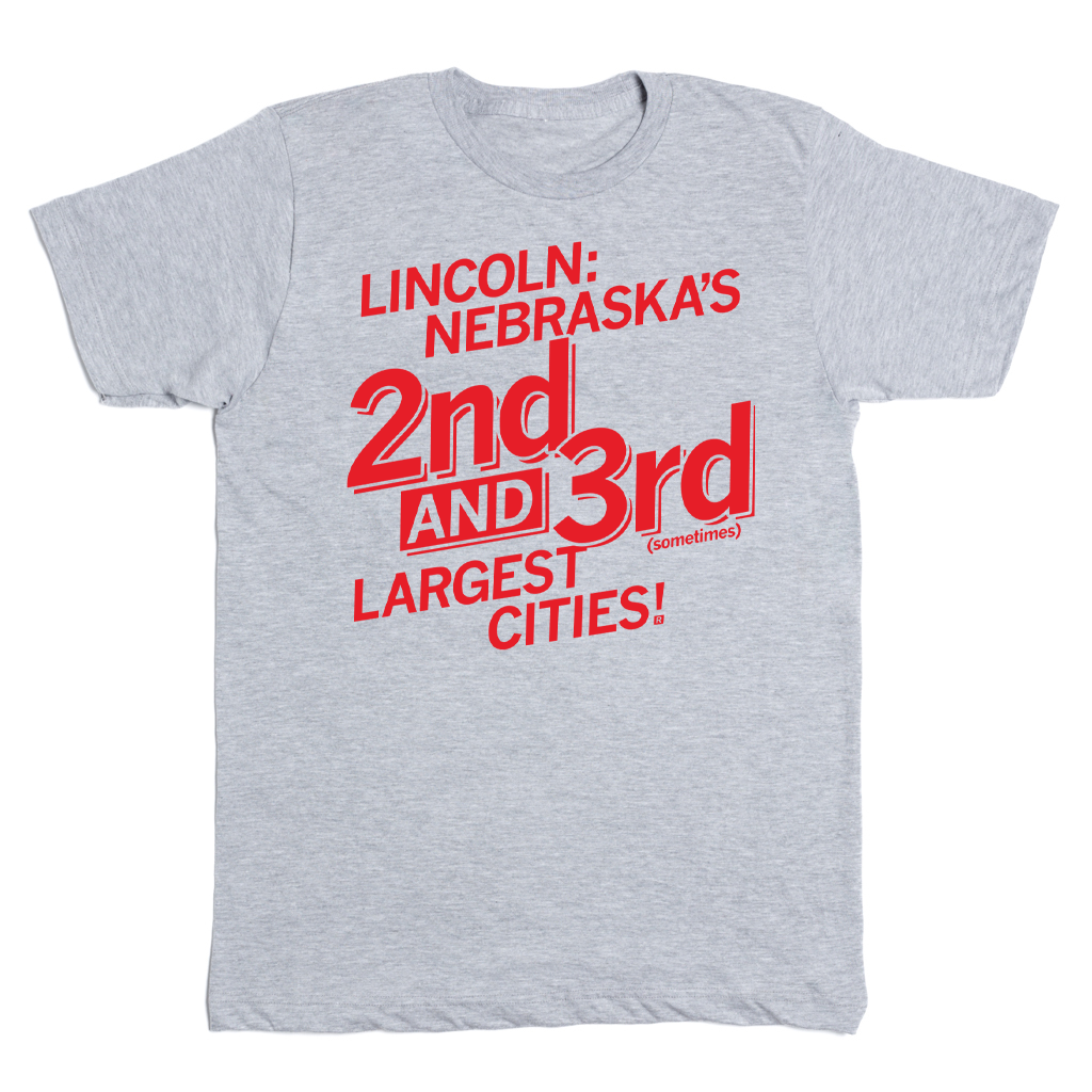 Heather gray Lincoln, Nebraska t-shirt with red text reading: LINCOLN: NEBRASKAS 2nd AND 3rd (sometimes) LARGEST CITIES!.