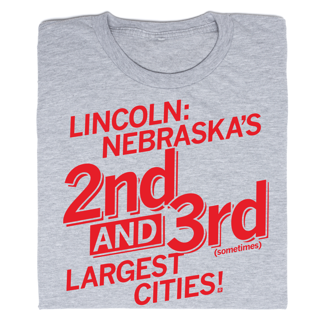 Heather grey t-shirt with red text that reads, Lincoln: Nebraska’s 2nd and 3rd (sometimes) largest cities!.