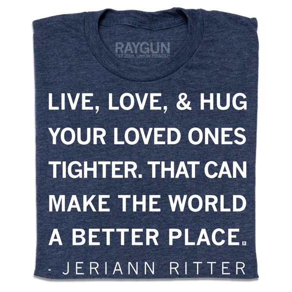 A folded heather navy t-shirt with white ink text that says, 