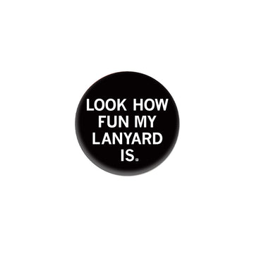Black circular RAYGUN button featuring the white text, LOOK HOW FUN MY LANYARD IS.