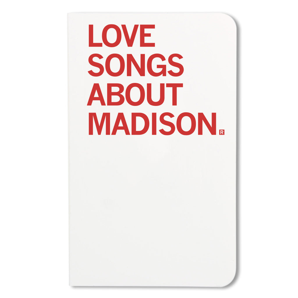 A white RAYGUN notebook cover featuring the red text LOVE SONGS ABOUT MADISON.