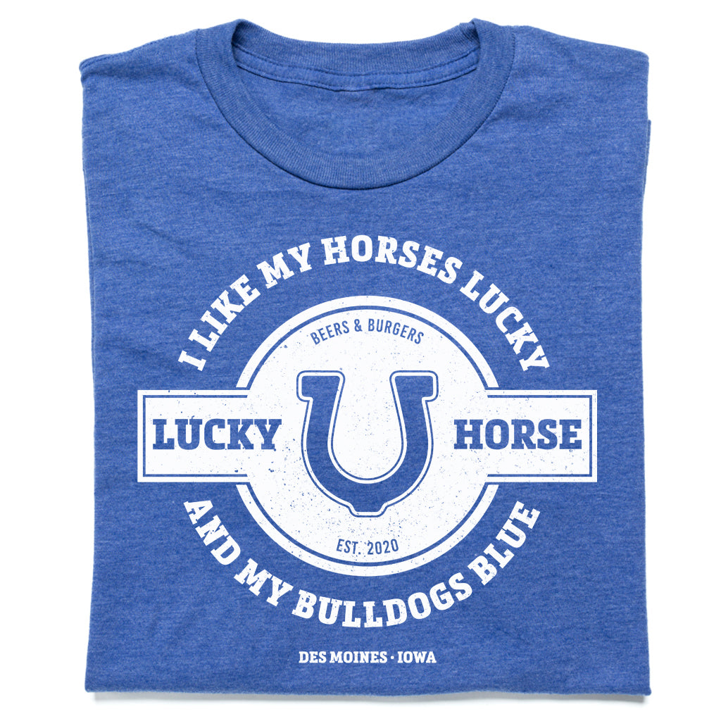 Union-made blue heathered RAYGUN T-shirt featuring a white graphic of a horseshoe and the text I Like My Horses Lucky and My Bulldogs Blue, Beers & Burgers, Est. 2020, Des Moines, Iowa.