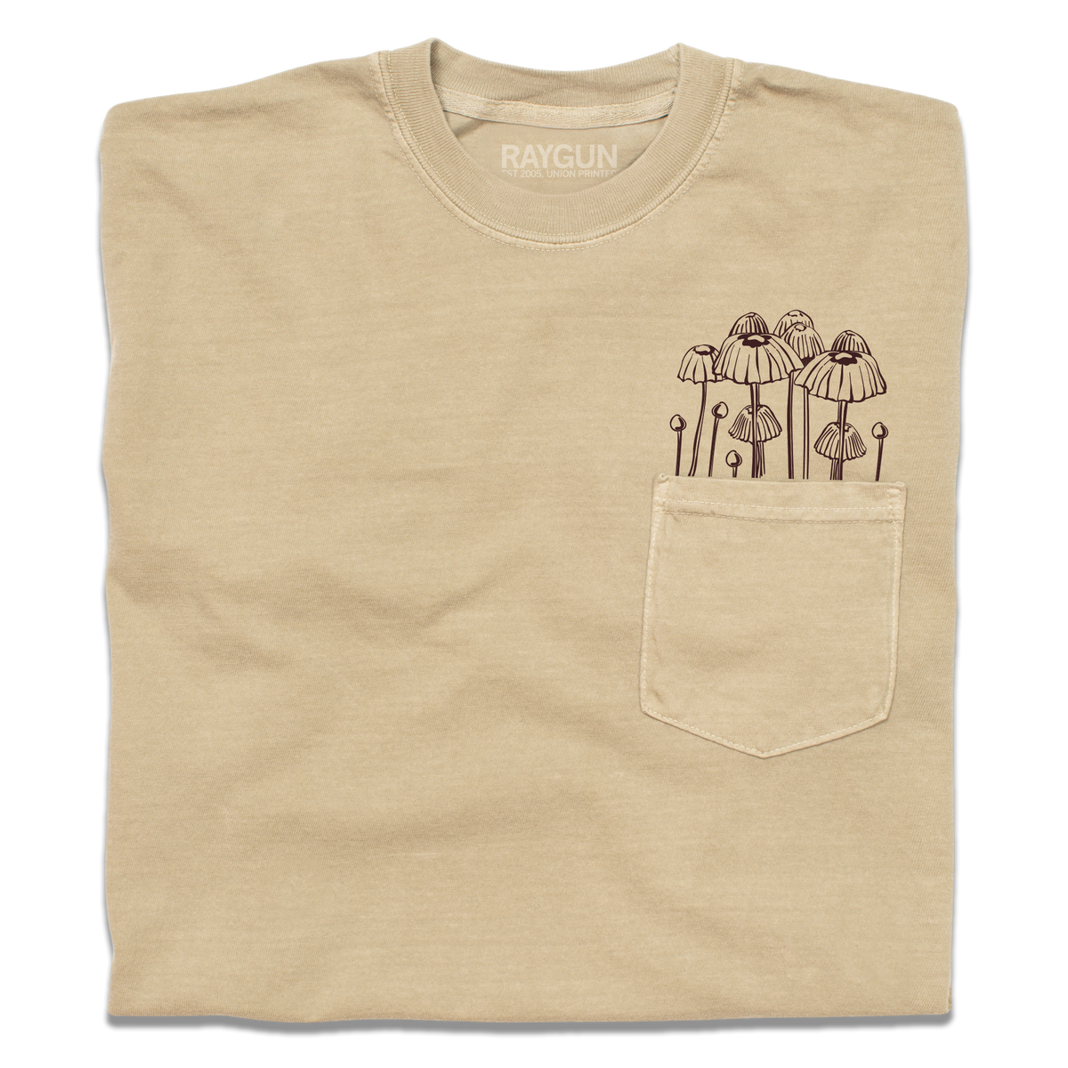 Tan heavyweight pocket tee with a brown line-art illustration of mushrooms growing out of the pocket.
