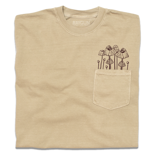 Tan heavyweight pocket tee with a brown line-art illustration of mushrooms growing out of the pocket.