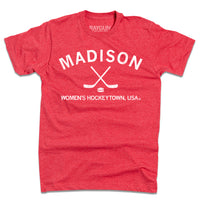 Heather red shirt with white ink that reads "Madison. Women's Hockeytown, USA." with crossing hockey sticks and a puck in the center.