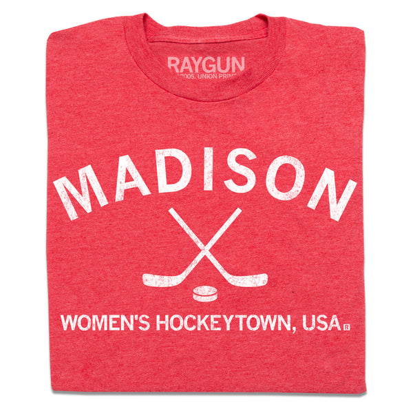 A folded heather red t-shirt with white ink that reads 