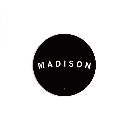 A black circular RAYGUN vinyl sticker featuring the white text MADISON in an arch with a small R symbol below it.