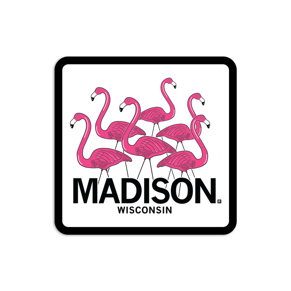 White & pink sticker depicting six lawn flamingos looking in different directions above "Madison Wisconsin" in black text