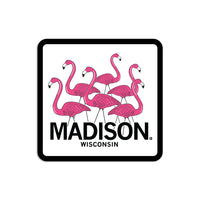 White & pink sticker depicting six lawn flamingos looking in different directions above "Madison Wisconsin" in black text