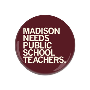 A circular maroon RAYGUN button with white text that reads, MADISON NEEDS PUBLIC SCHOOL TEACHERS.