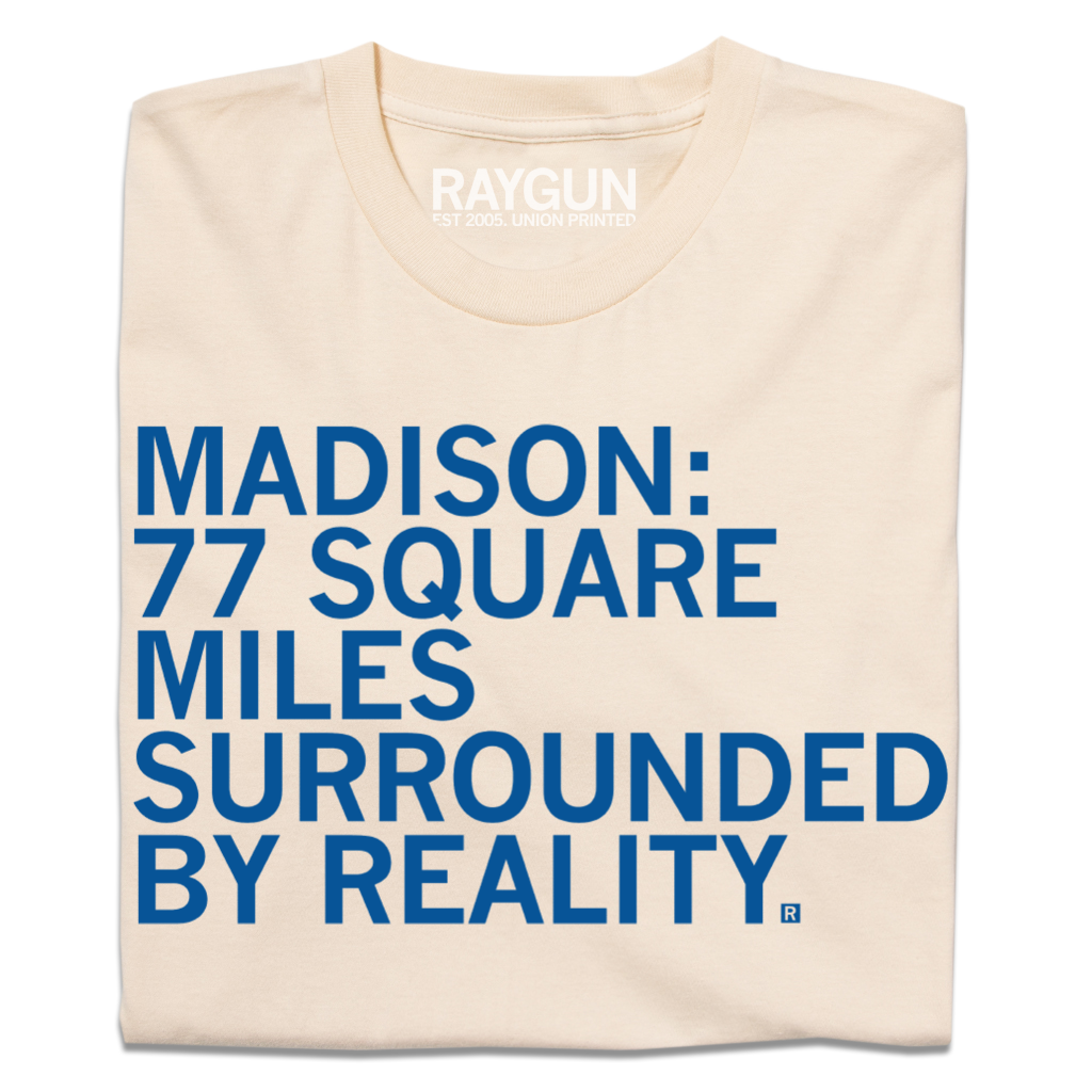 Cream-colored Madison t-shirt featuring blue text that reads: MADISON: 77 SQUARE MILES SURROUNDED BY REALITY.