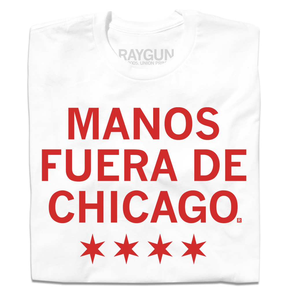 A white t-shirt with scarlet red ink that says, "Manos fuera de Chicago" over four red stars, like the Chicago flag.