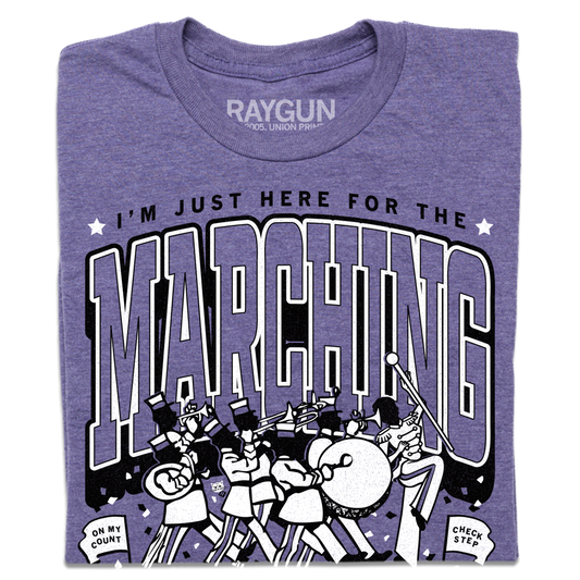 Purple heather crew neck t-shirt featuring a black and white graphic of a marching band and the text Im just here for the marching.